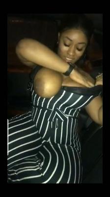 Flashing her big black tits in the car